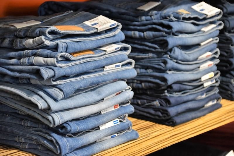 Folded denim jeans stacked on a shelf